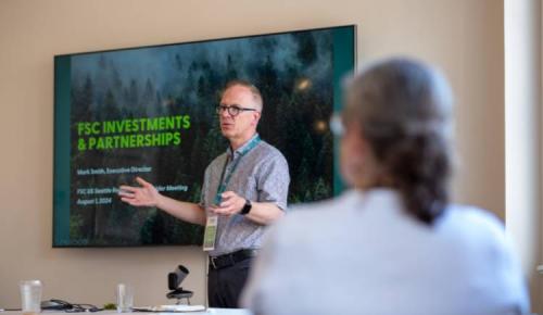 Speaker presents on FSC investments and partnerships to attendees.