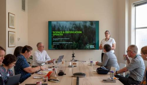 Presenter shares science and certification updates with the group.