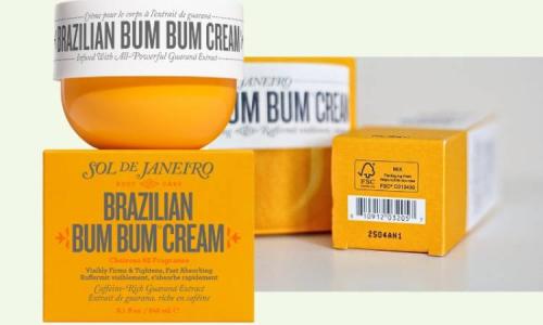 Product display of Sol de Janeiro’s Brazilian Bum Bum Cream featuring its signature yellow jar and FSC-labeled paper packaging, highlighting the brand’s commitment to responsibly sourced materials.
