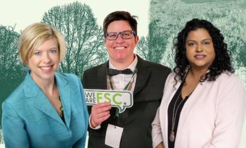 Three people are standing together smiling in front of a backdrop with forest imagery, representing FSC North America leadership.