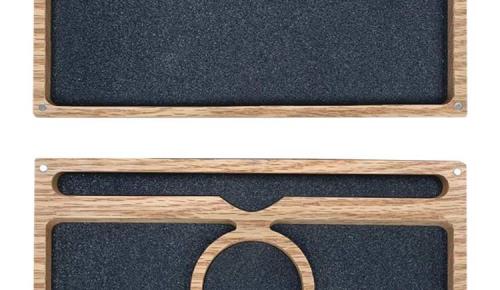 Two wooden compartments lined with black foam show the inside layout of the dice vault.