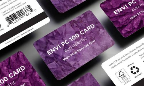 Stack of purple ENVI PC 100 cards made from 100% post-consumer recycled fiber, featuring FSC and recycling symbols.
