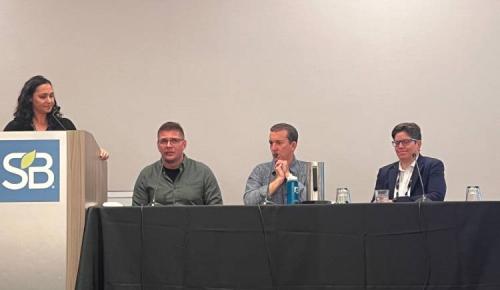 Moderator listens as panelists speak during the session.