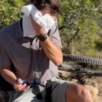 Man wiping face with wipe